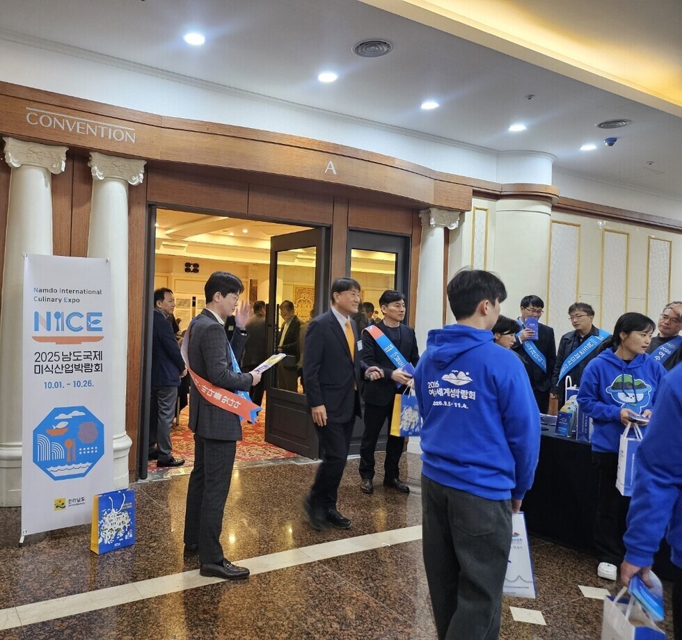 2025 남도국제미식산업박람회 입구에서 파란색 띠를 두르고 홍보 활동중인 관계자들 모습